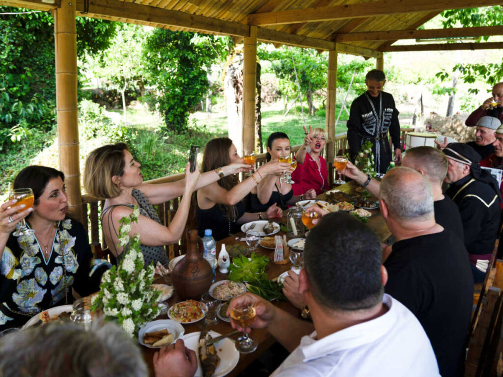 The people making a toast of drinks at a Georgian supra