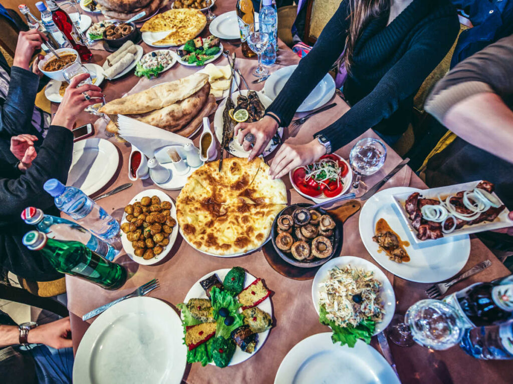 People around a table full of Georgian traditional foods