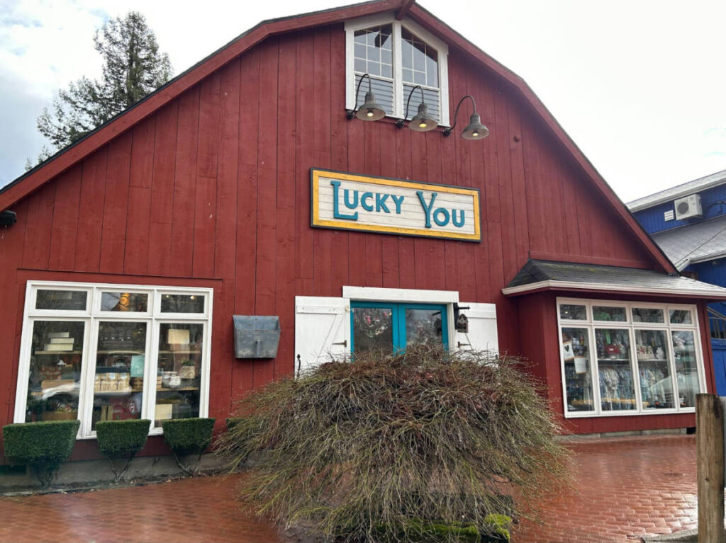 Exterior view of a bright red barn-like gift shop at Gilman Village