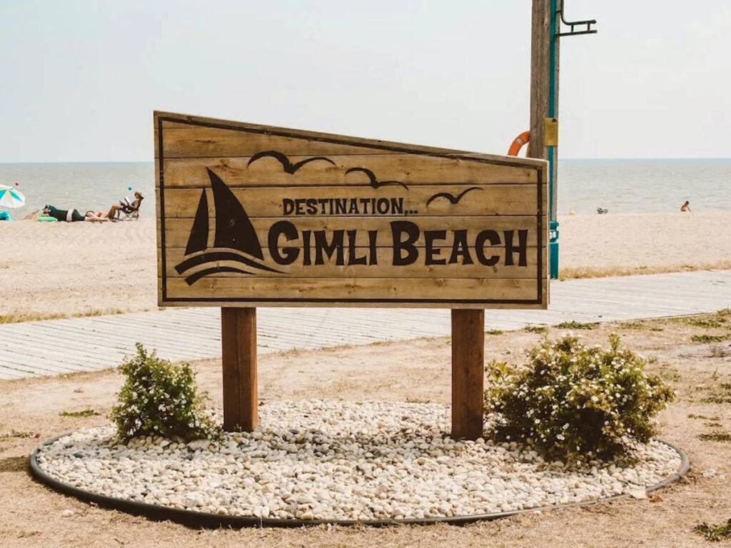 Signage of the Gimli Beach near the shoreline
