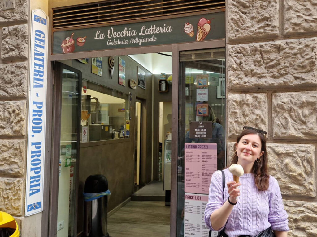 The author Giorgia Giustolisi, holding a cone of gelato outside  La Vecchia Latteria