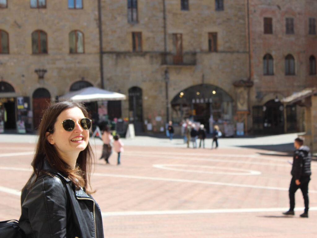 The author Giorgia Giustolisi, smiling for a photo at Piazza Grande