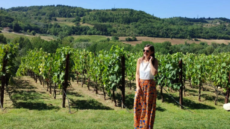The author Giorgia Giustolisi, posing for a photo by the vineyards in Tuscany