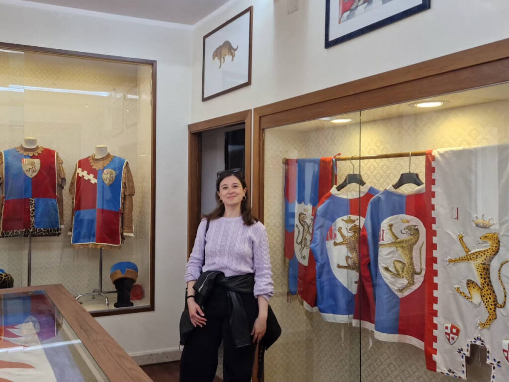 The author Giorgia Giustolisi, smiling inside the Museum of Contrada della Pantera
