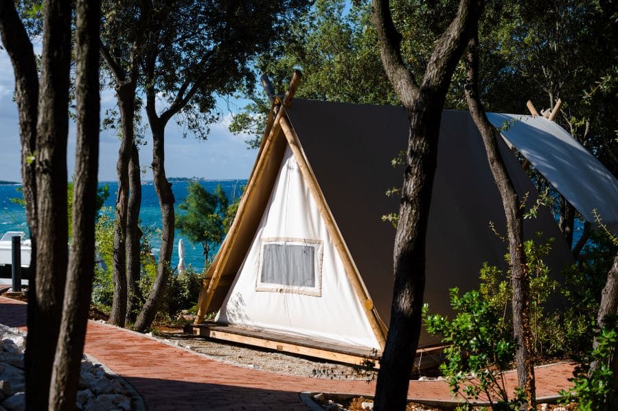 A Glamping tent is perched on the beach by Croatia's blue and turquoise Adriatic Sea