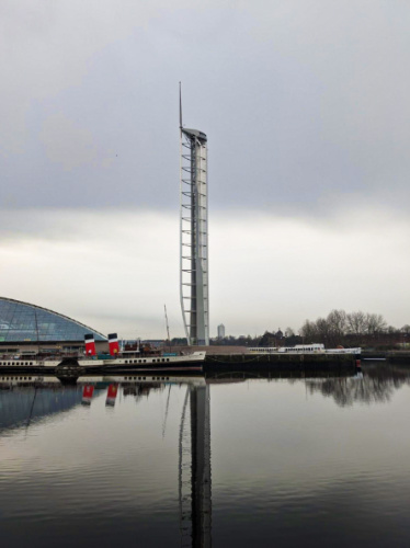 View of the Glasgow Tower reflecting on the water on a gloomy day
