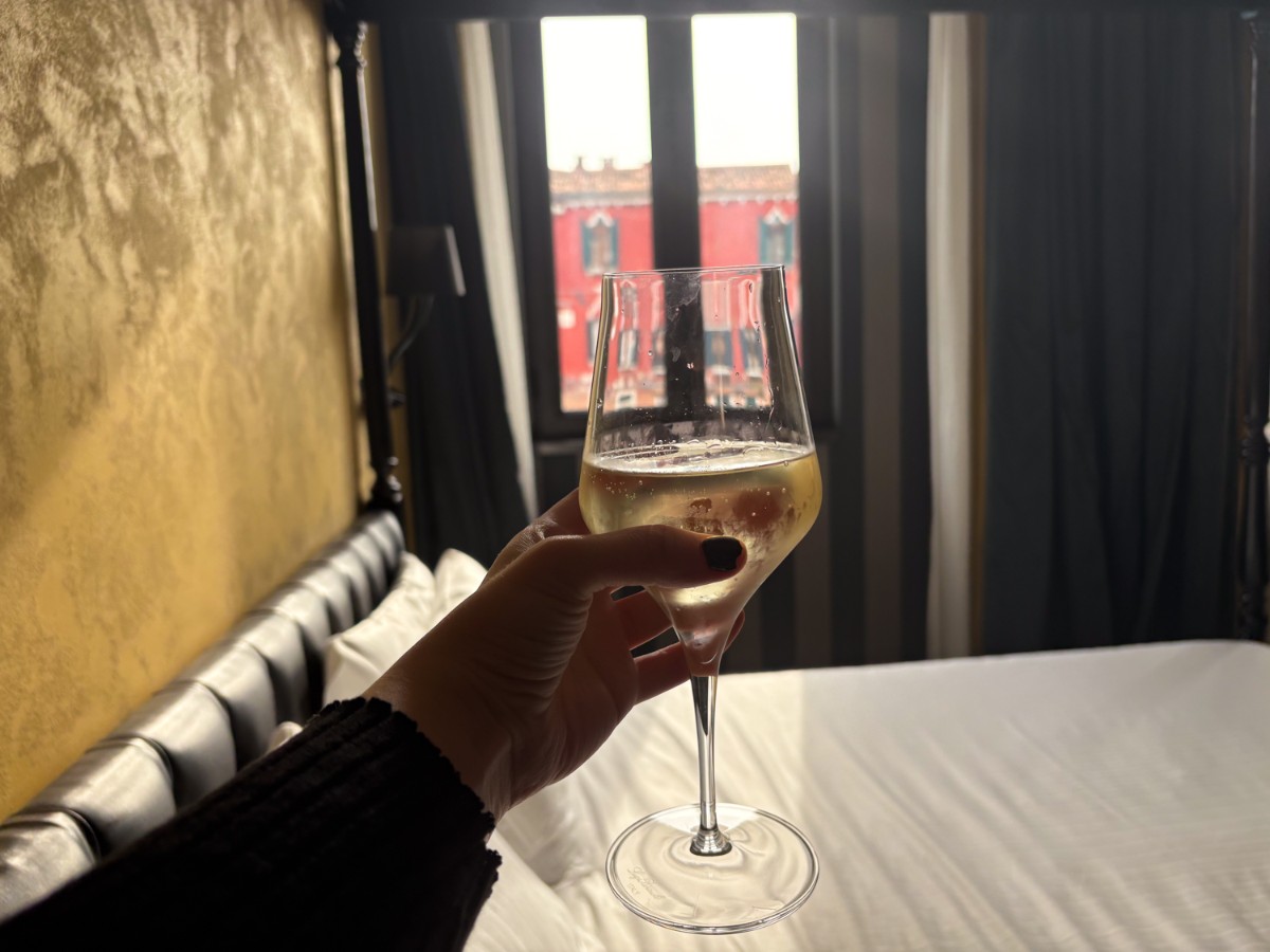 Holding a glass of prosecco