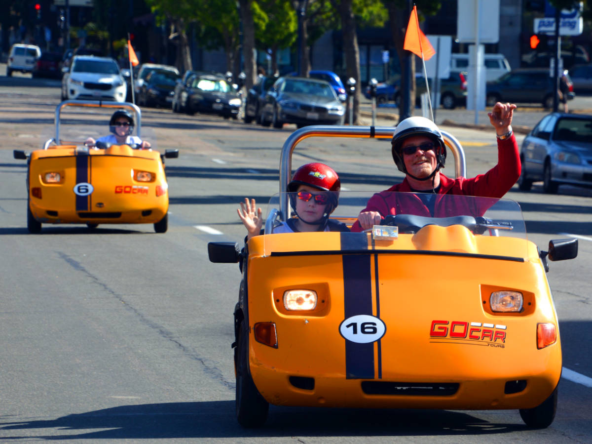 Father and son riding the GoCar while touring San Diego