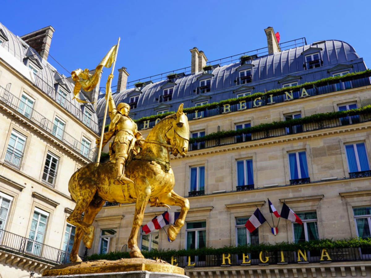 View of the Golden Joan of Arc statue in front of Hotel Regina Louvre
