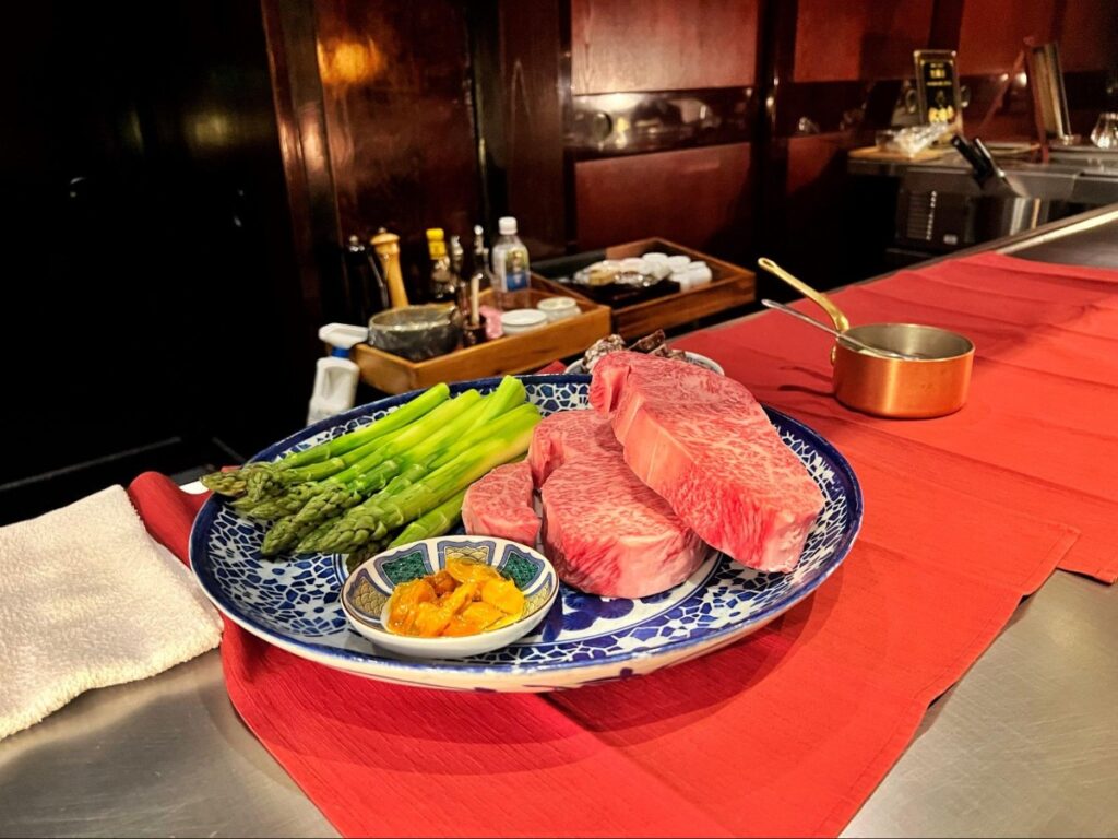 A plate of Akita Beef and giant asparagus at Gomei Akita Beef Teppanyaki