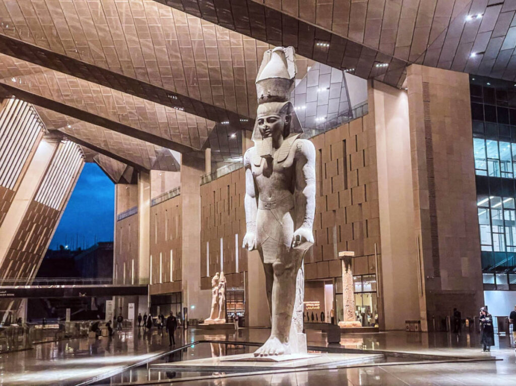 An old statue displayed inside the Grand Egyptian Museum