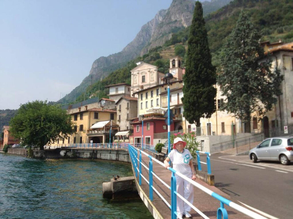 The author's grandma posing near the Lake Como
