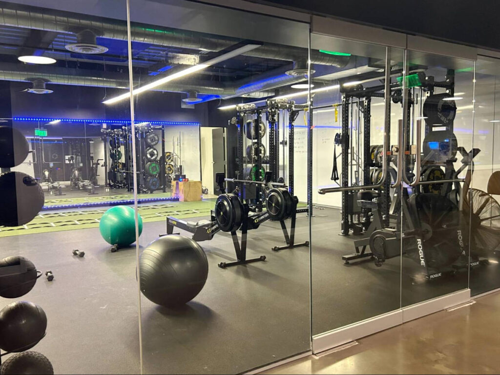 View of the equipment and the huge mirror inside the gym
