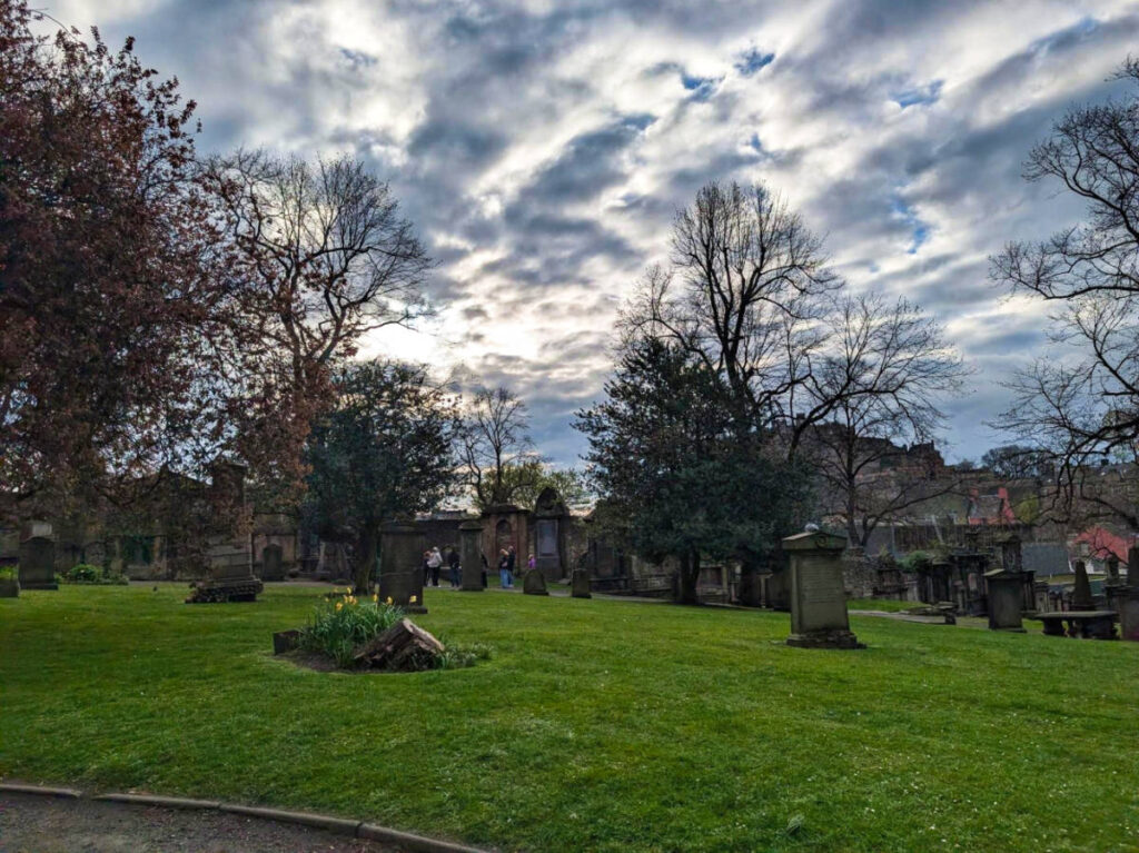 View of the tombstones and the lush greenery at Greyfriars Kirkyard
