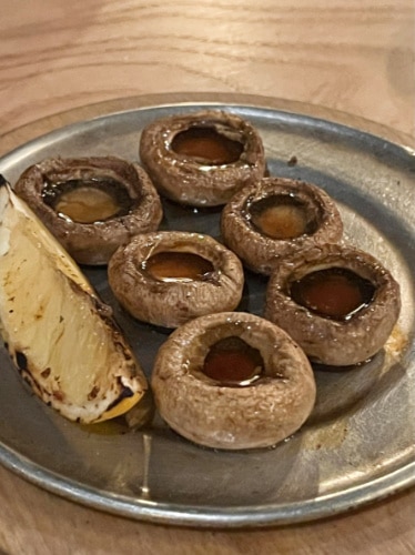 Grille mushrooms and pineapple on a plate in San Ho Won