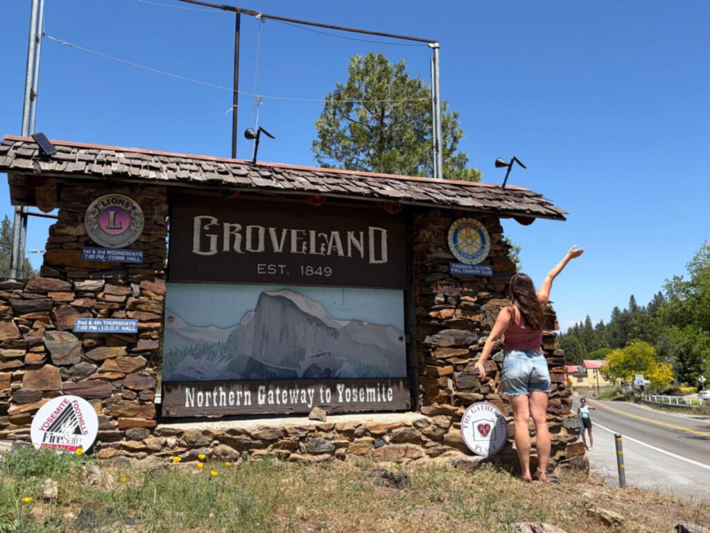 Writer Laura posing for a photo by the Groveland sign