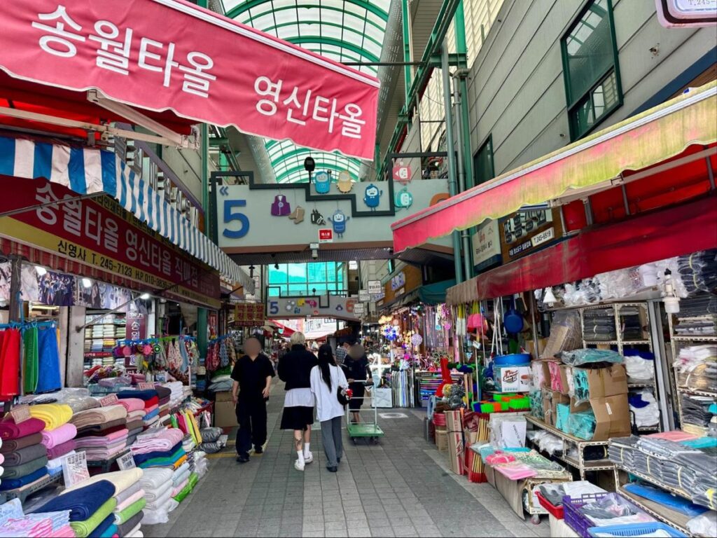 People walking along the market stalls at Gukje Market