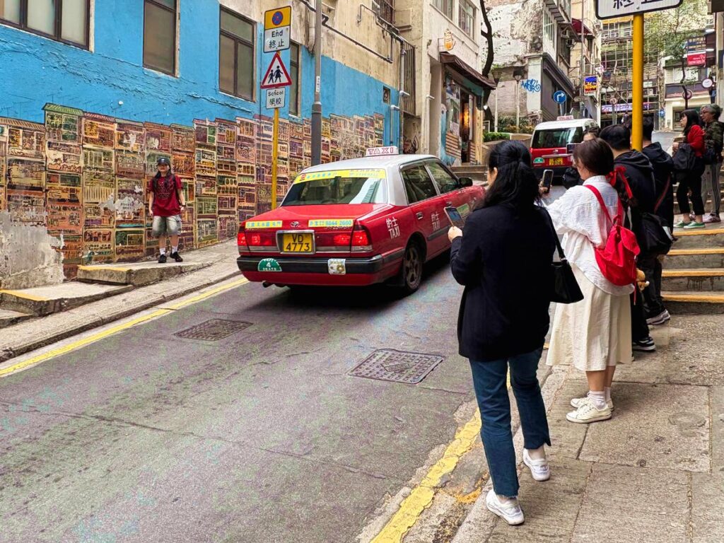 A tourist taking a picture at the HK Central Murals
