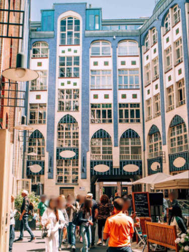 People wandering around Hackesche Höfe surrounded by colorful  buildings