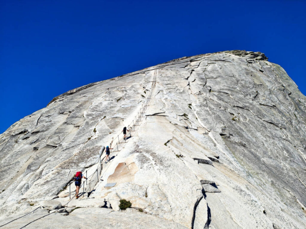 View of the hikers, hiking to the steep cable trail to the Half Dome