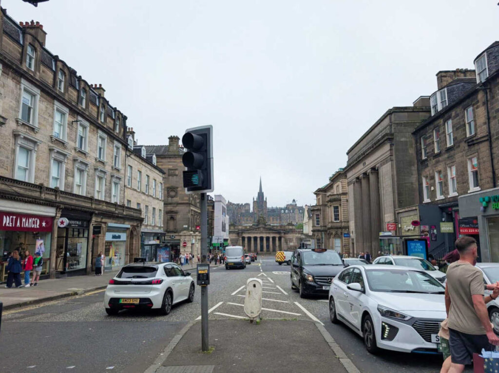 A busy street with cars parked along both sides in Hanover Street
