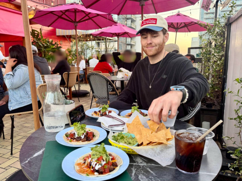 The author's boyfriend, Michael, enjoying the happy hour tacos and guacamole