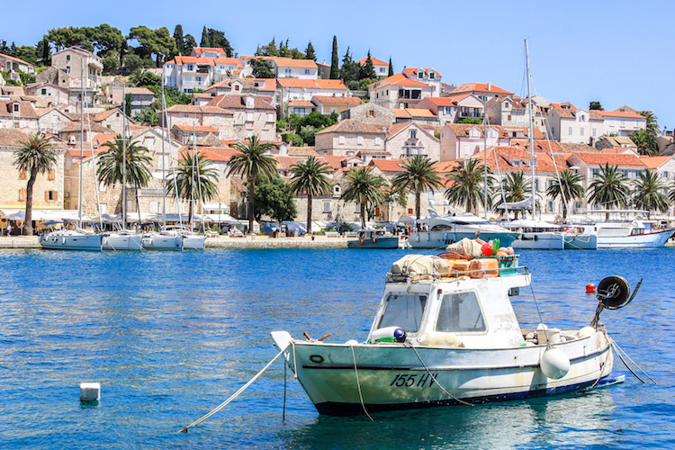 A small boat is docked in the harbor of Hvar Island