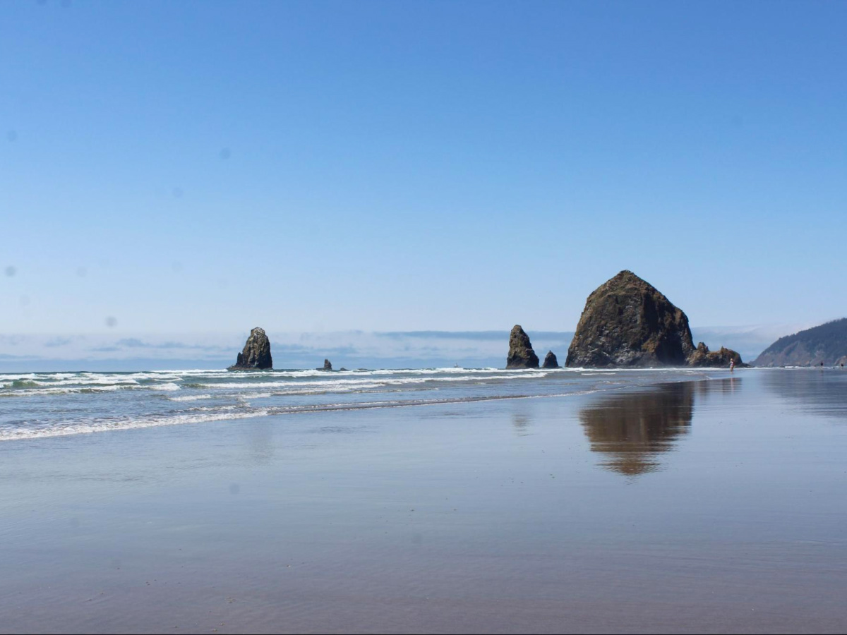 View of the vast shoreline and the Haystack Rock at Cannon Beach