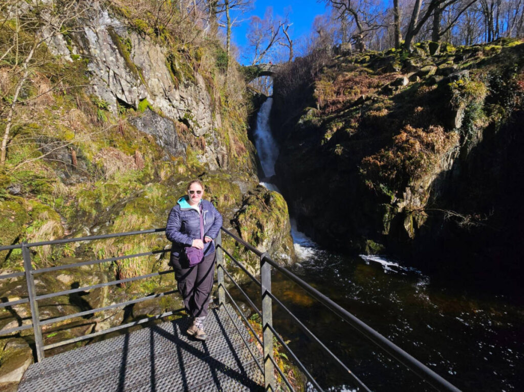 The author Heather Cole, posing for a photo in front of the viewing deck of the Aira Force