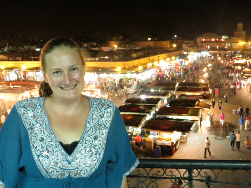 The author Heather Cole, skmiling for a photo with an overlooking view of the Night Market from Le Grand Balcon Cafe Glacier