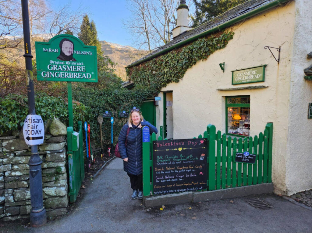 The author Heather Cole, smiling for a photo at the Grasmere Gingerbread shop