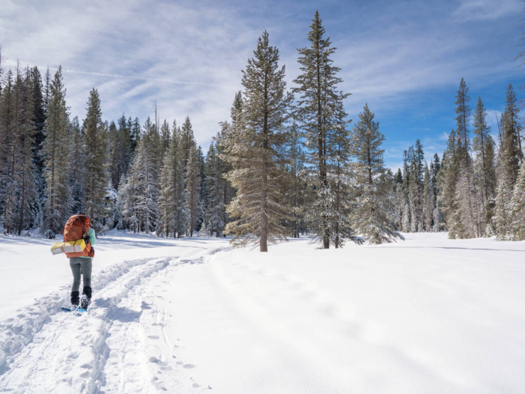 A hiker snowshoeing in Yosemite National Park in winter