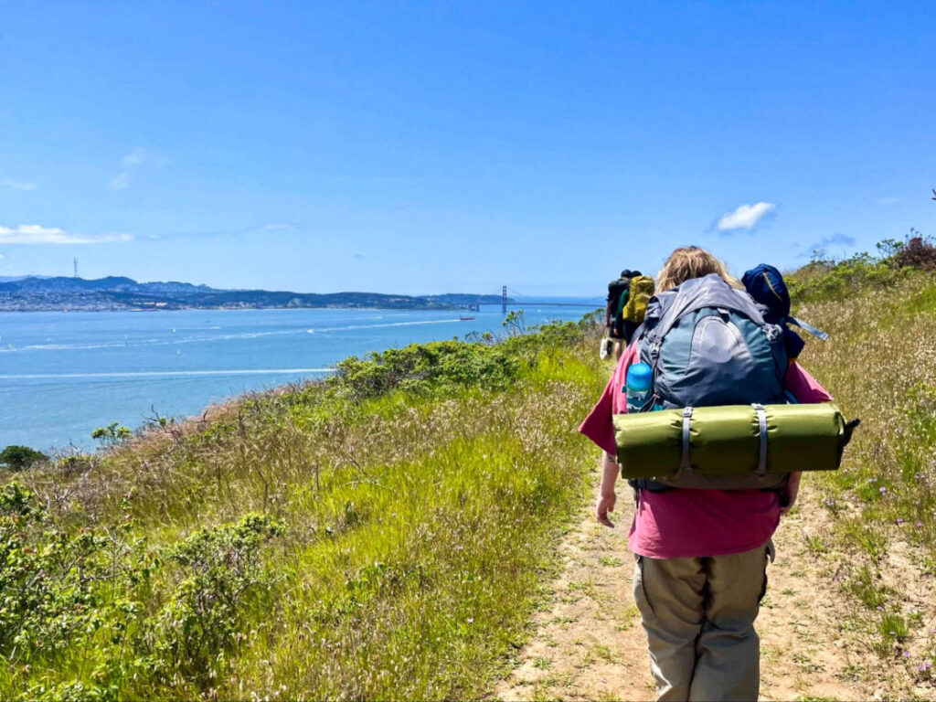 A hiker on the trail with San Francisco views