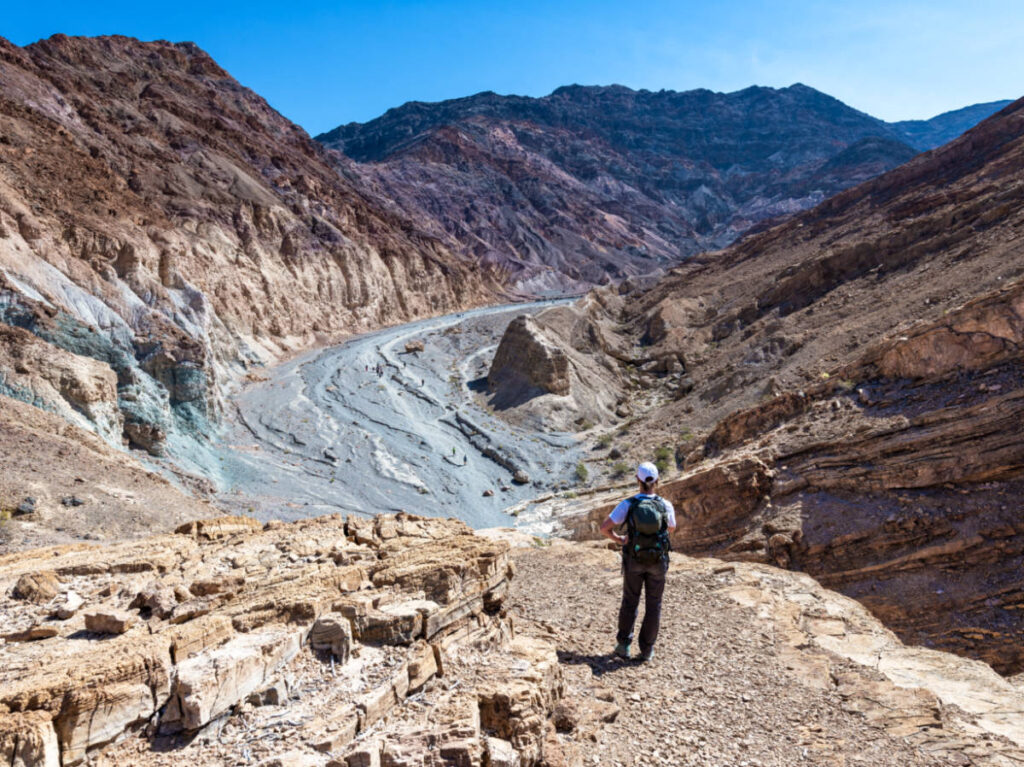 A hiker admiring the picturesque view at the Mosaic Canyon Trail