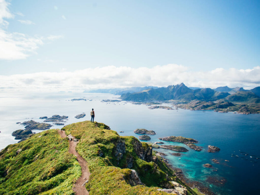 A hiker on top of the mountain, overlooking the mountains