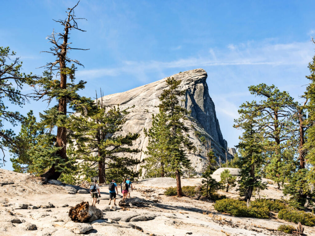 A group of hikers walking to the Half Dome