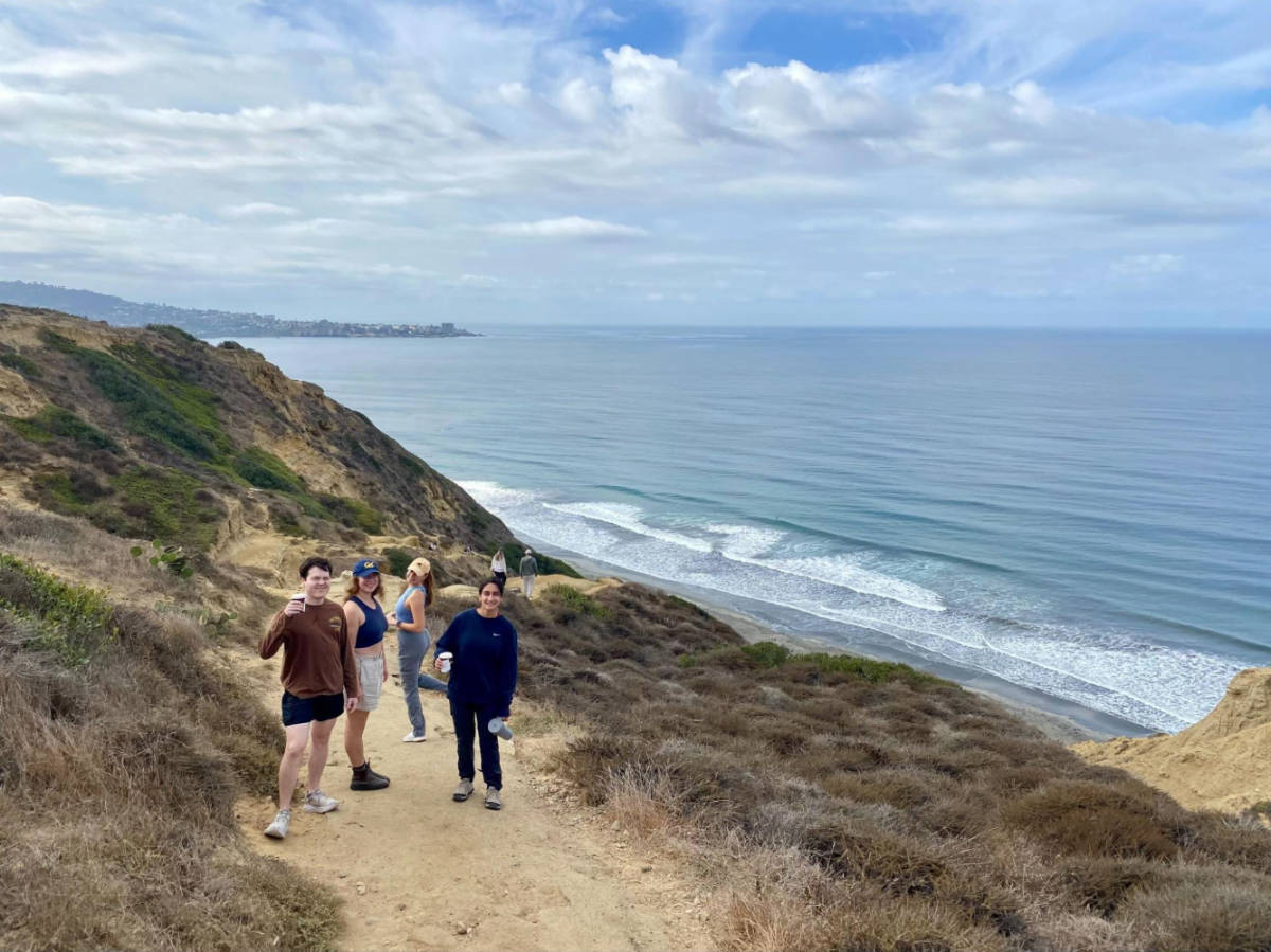 The author's friends hiking in La Jolla with an overlooking view of the beach