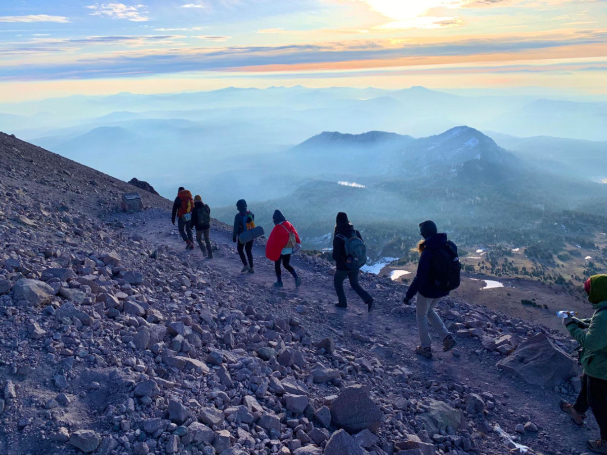 Group of hikers hiking down from the summit of Lassen Peak
