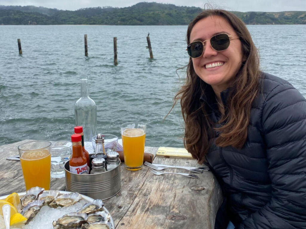 Author's partner eating oysters at Hog Island Oyster Farm