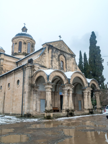 Outside view of the Holy Annunciation Church with puddles of muddy water infront