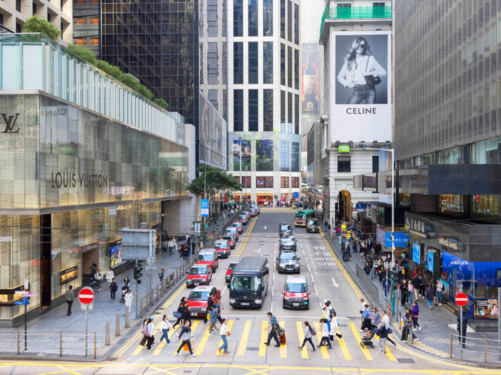 Overlooking view of the bustling street and the people crossing the pedestrian in Hong Kong Central