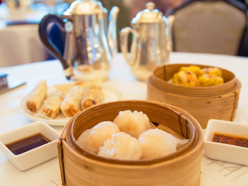 Dumplings, siu mai and spring rolls on the table