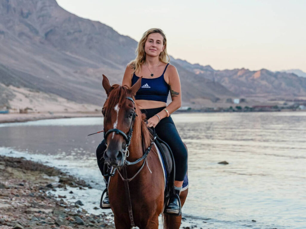 The author, Kate McMahon horseback riding in Egypt,