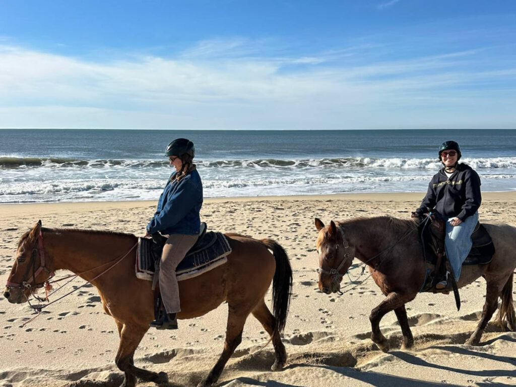 The author Laura McFarland and her partner, horseback riding along the Half Moon Bay