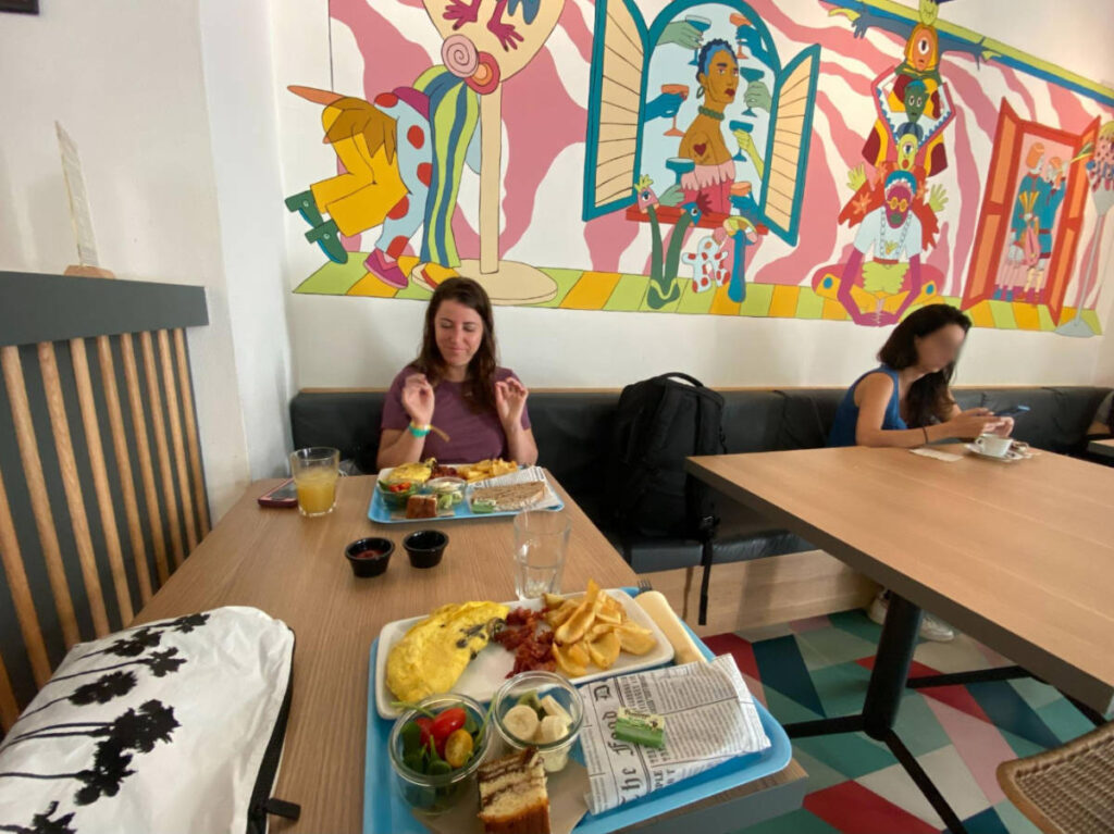 The author's friend enjoying a hostel breakfast