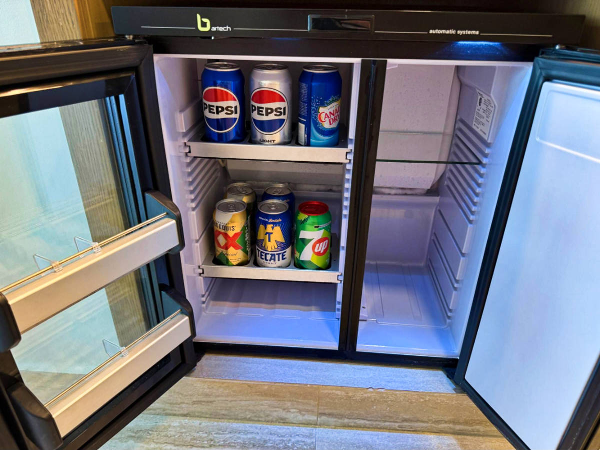 Soda cans inside the mini fridge