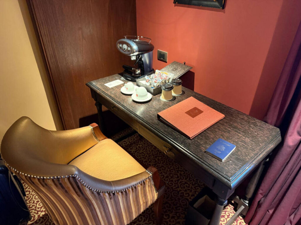 A espresso machine on the desk area inside the hotel suite
