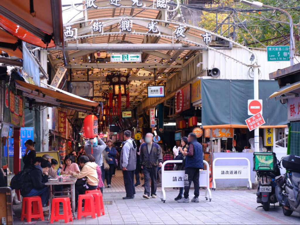 View of people and stores in Street Vendors in Huaxi Market