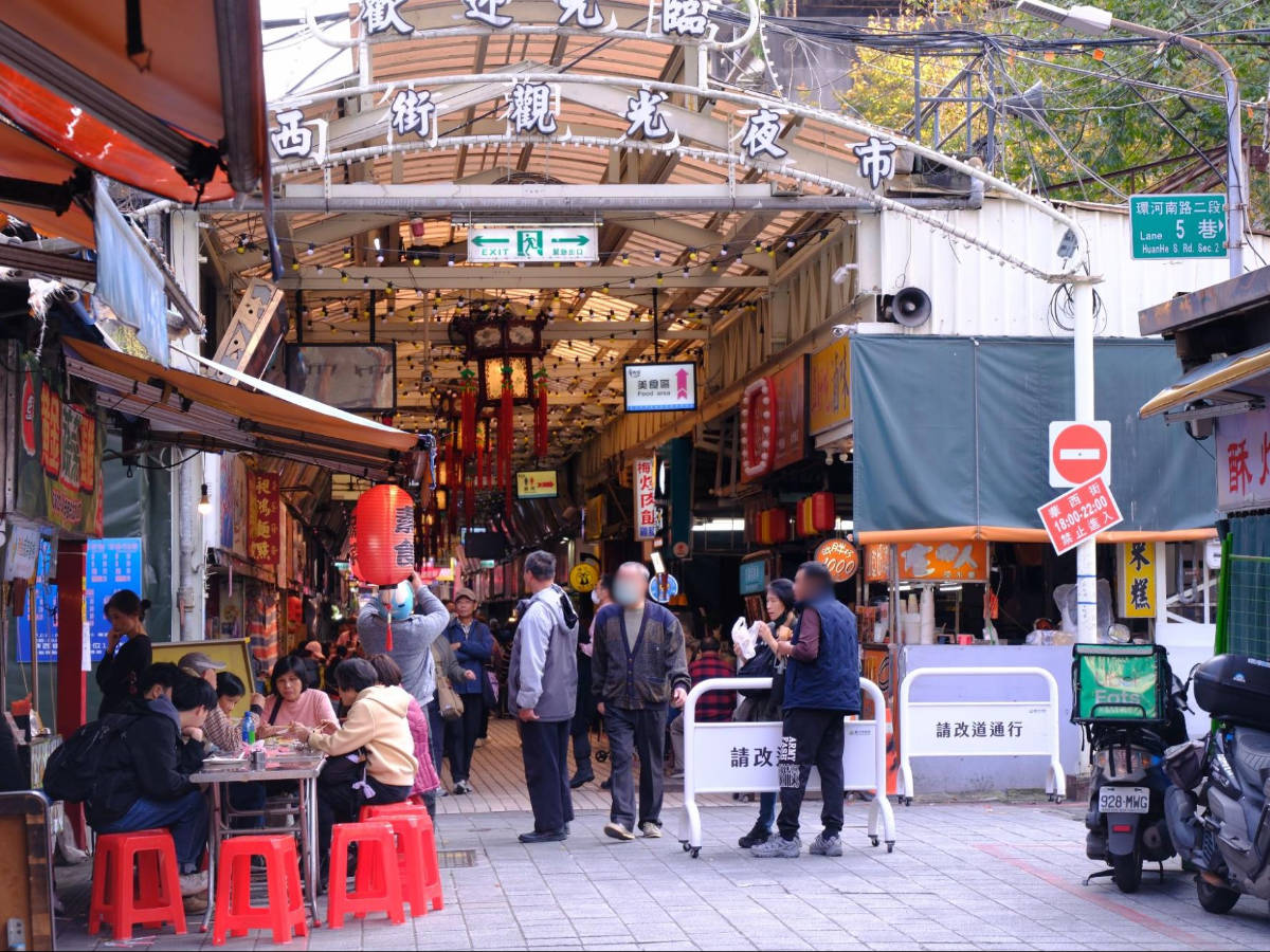 View of people and stores in Street Vendors in Huaxi Market