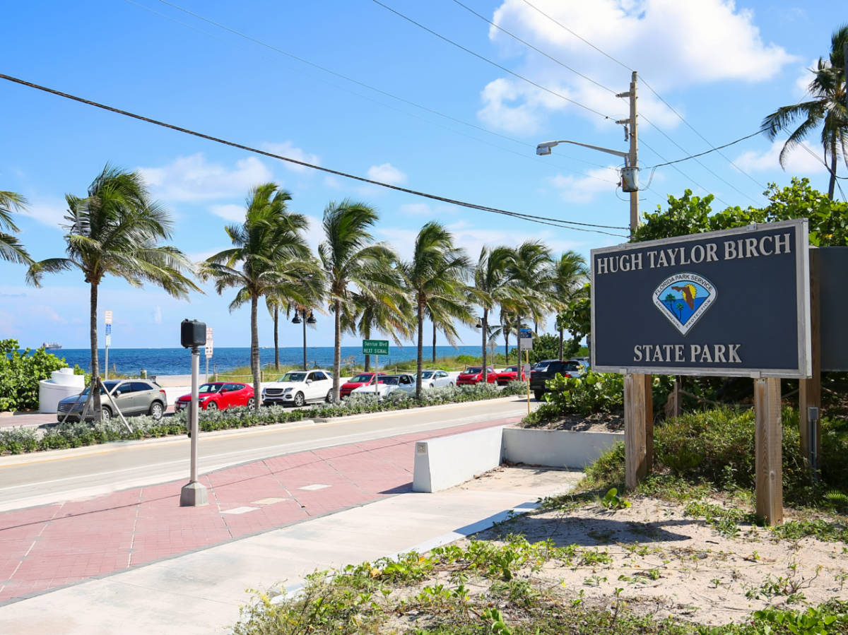 The Hugh Taylor Birch State Park Sign near the road and beach